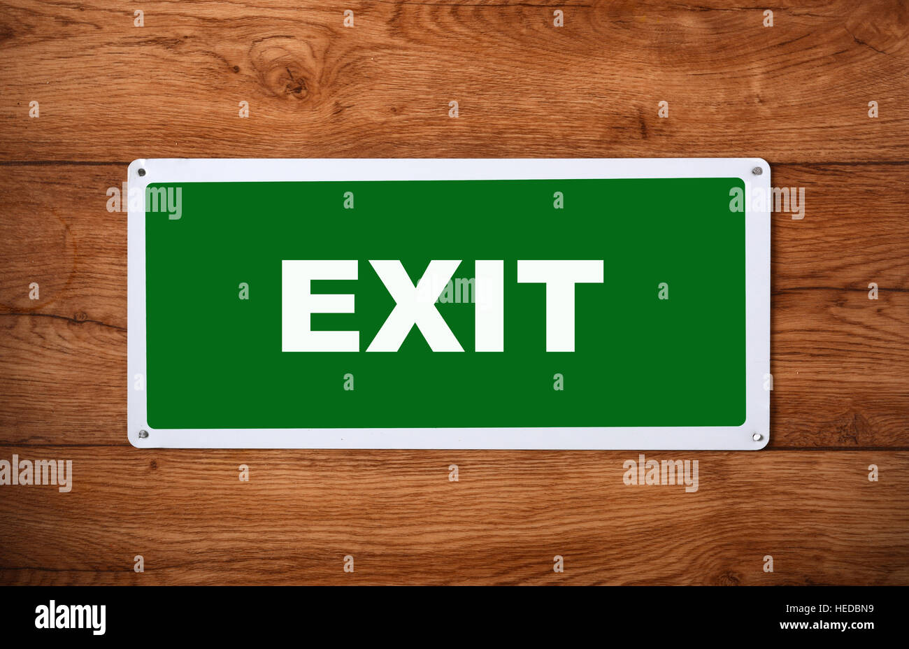 plaque with the inscription exit on the wooden wall Stock Photo