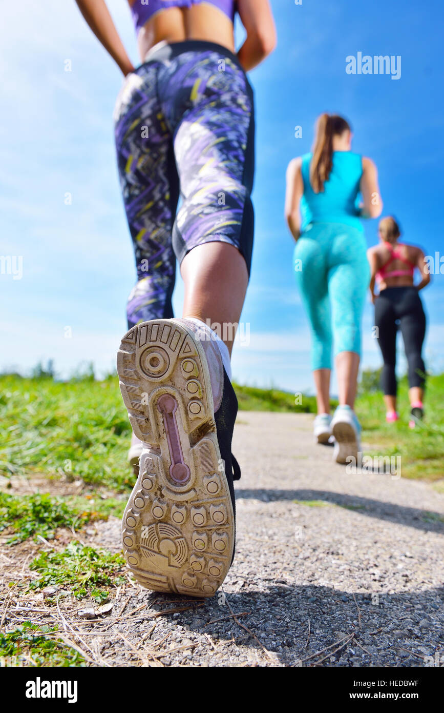 Three Female Joggers running together outdoors Stock Photo Alamy