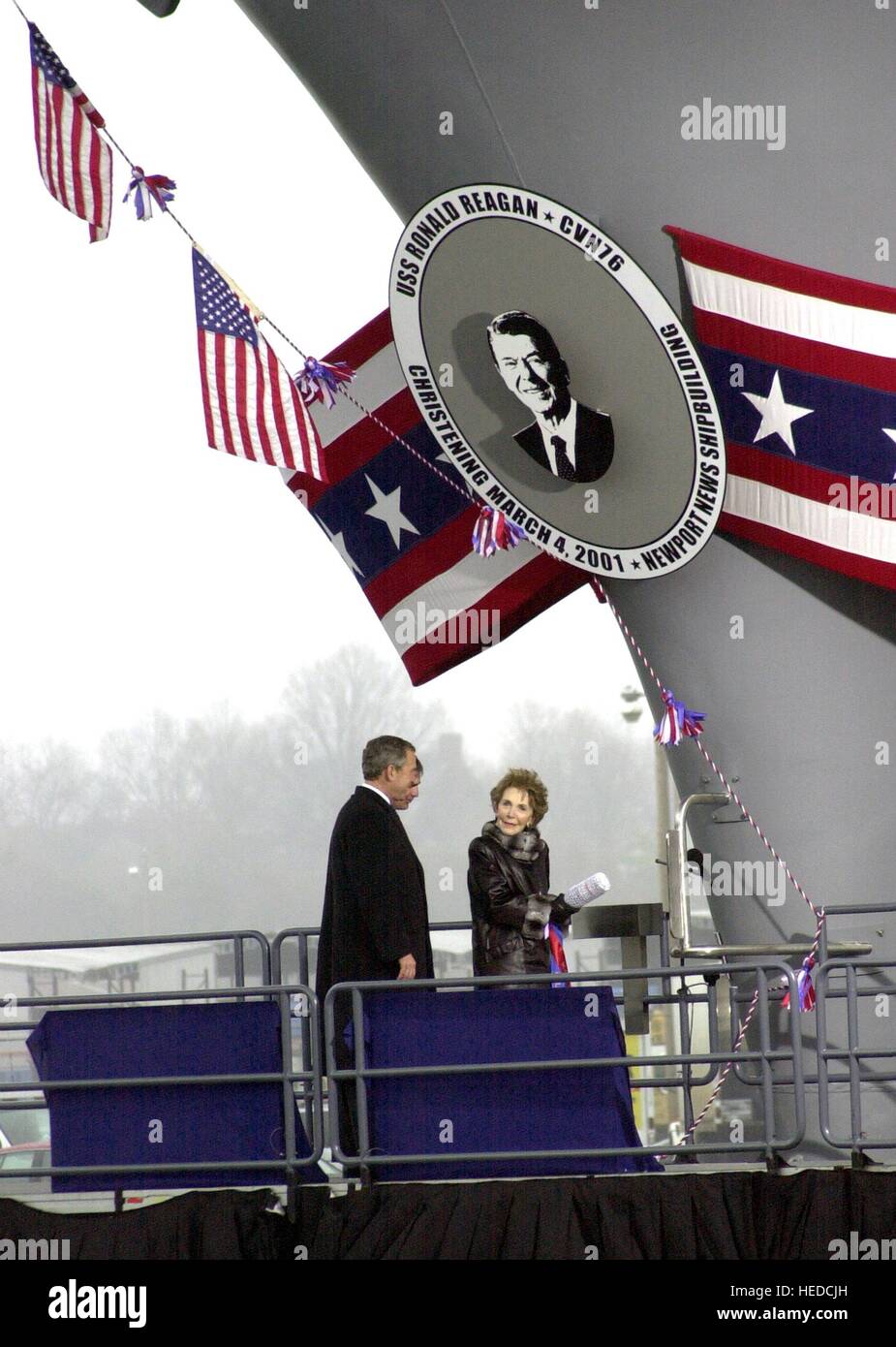 U.S. President George W. Bush and Newport News Shipbuilding President and CEO William Frick watch former First Lady Nancy Reagan christen the new USN Nimitz-class nuclear-powered aircraft carrier USS Ronald Reagan at the Northrop Grumman Newport News Shipbuilding facility March 4, 2001 in Newport News, Virginia. Stock Photo