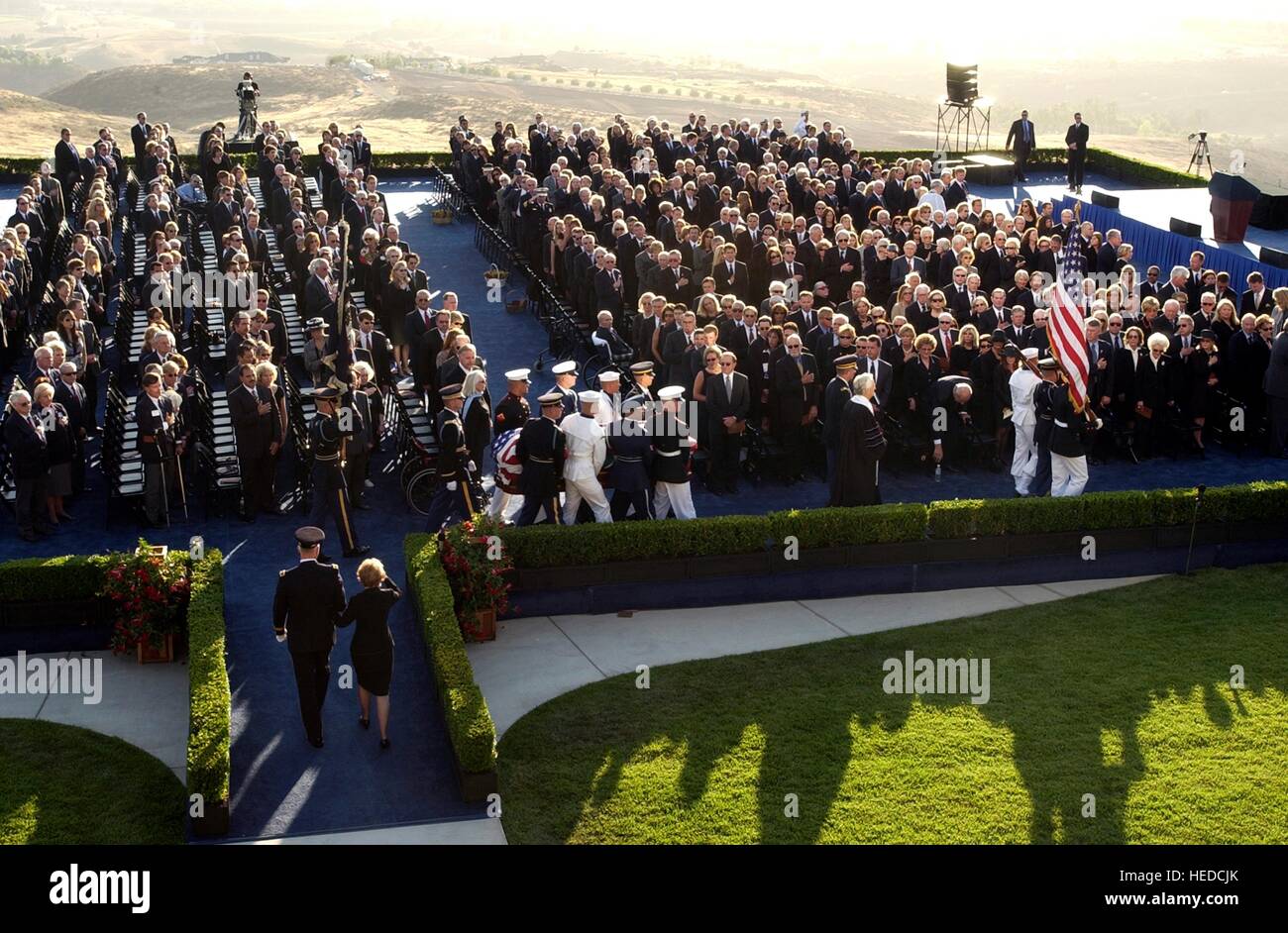 Soldiers from the USN Ceremonial Guard escort the flag-covered casket of former U.S. President Ronald Reagan during his state funeral at sunset June 11, 2004 in Simi Valley, California. Stock Photo