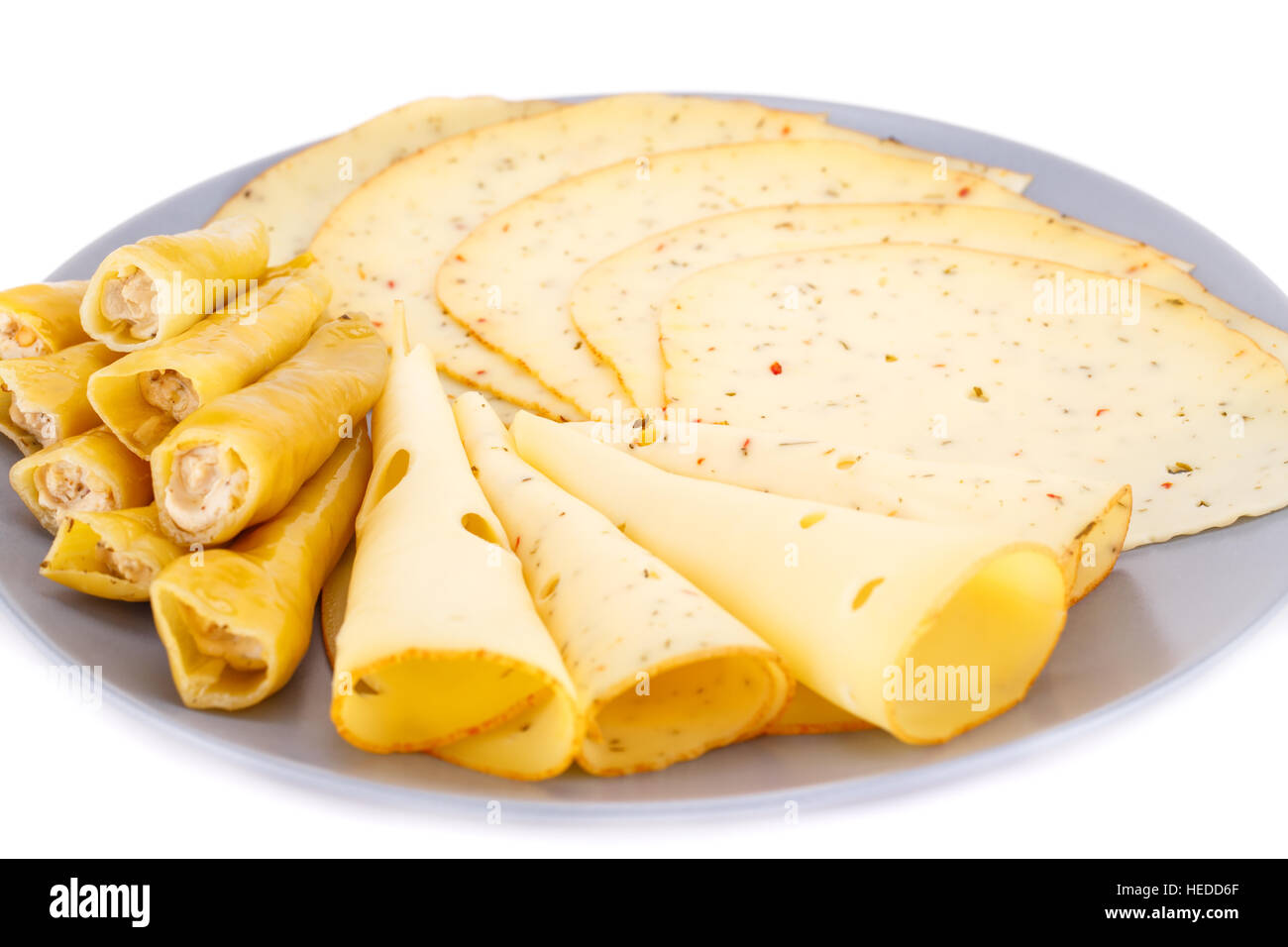 Cheese and pepper on gray plate on white background. Stock Photo
