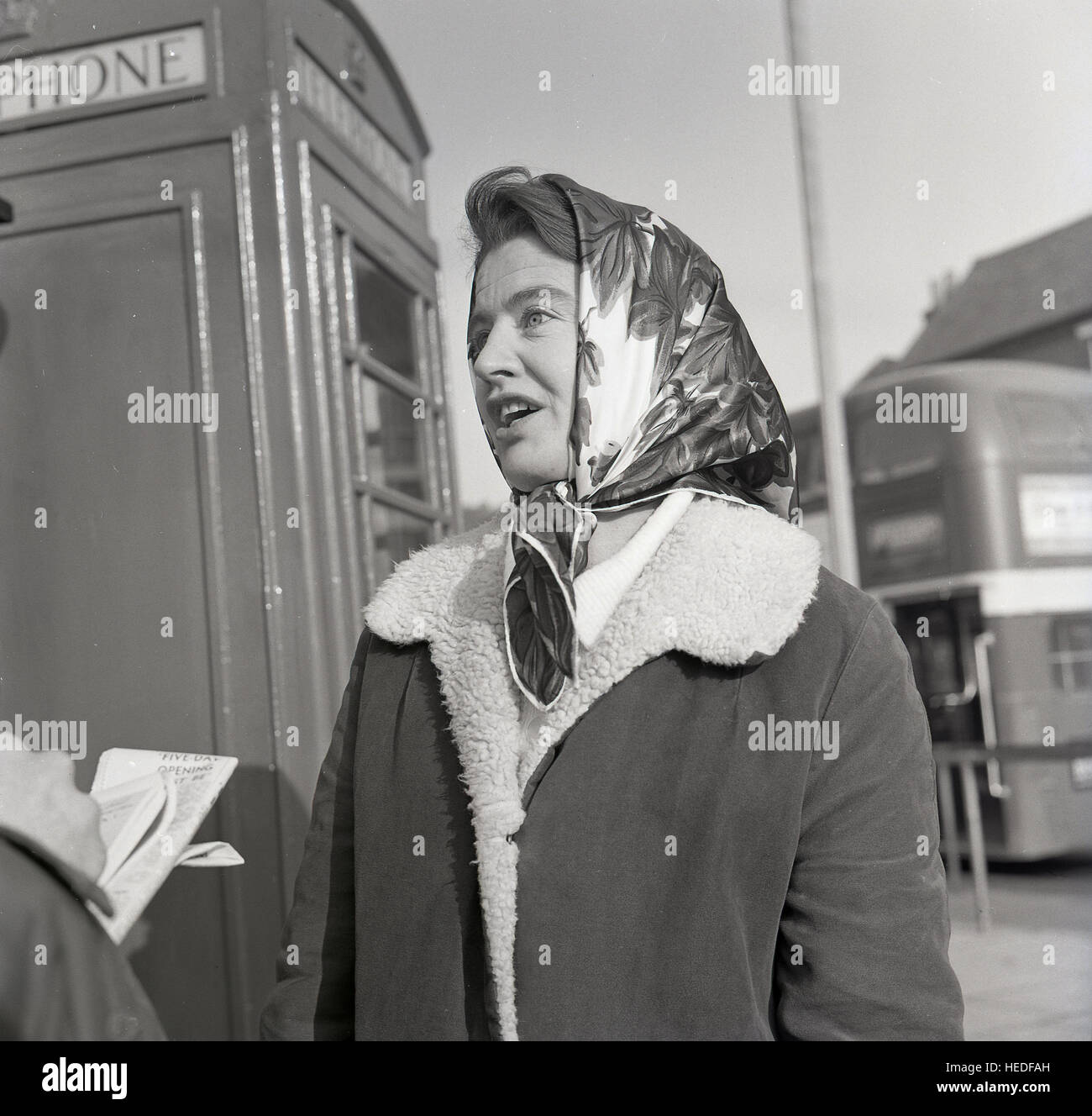 1960s, historical, lady wearing sheepskin coat and headscarf taking part in  a street survey Stock Photo - Alamy