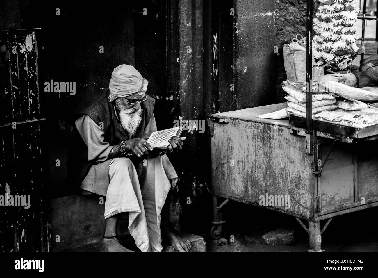 A hindu sadhu reading his holy book. Stock Photo