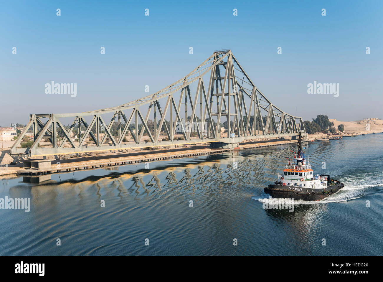 Tug Boat passes El Ferdan Railway Bridge in the Suez Canal near