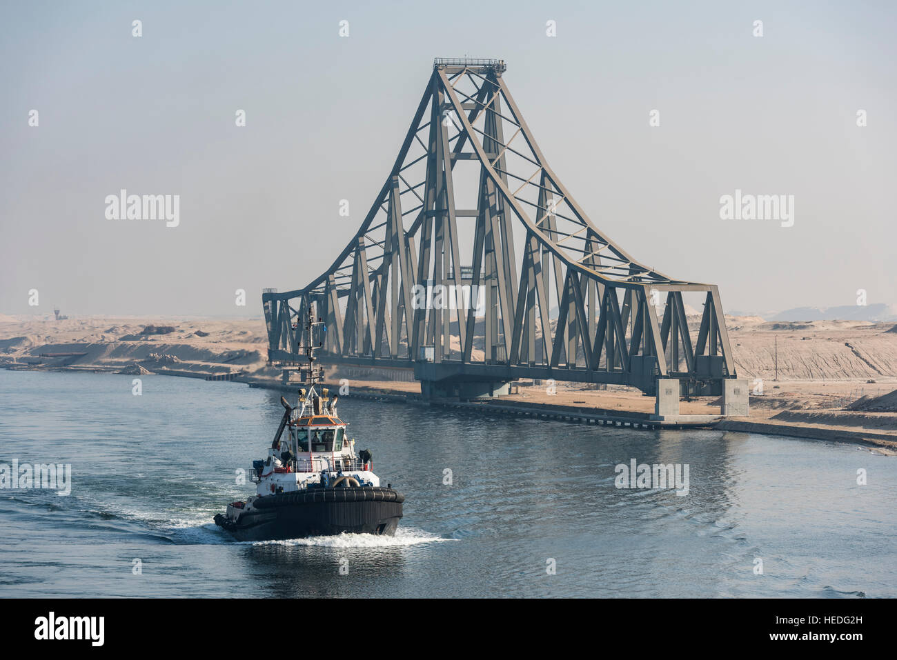 Tug Boat passes El Ferdan Railway Bridge in the Suez Canal near