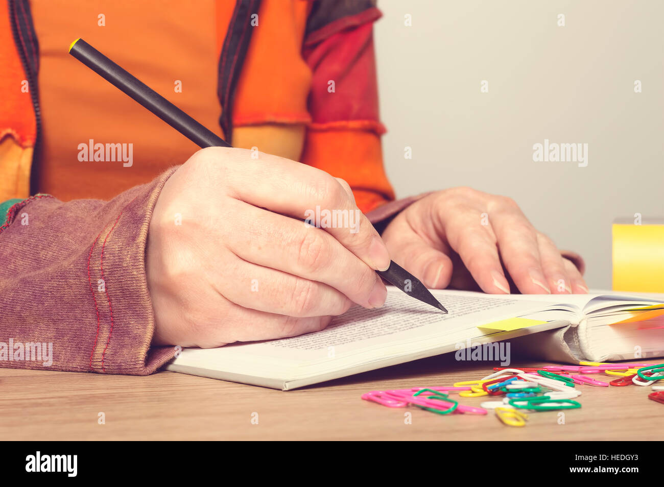 Female hands with pen writing on book. Education concept. Stock Photo