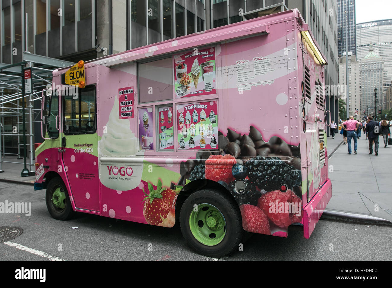 A Yogo truck is parked on a corner of Park Avenue. The truck is a mobile frozen yogurt store. Stock Photo
