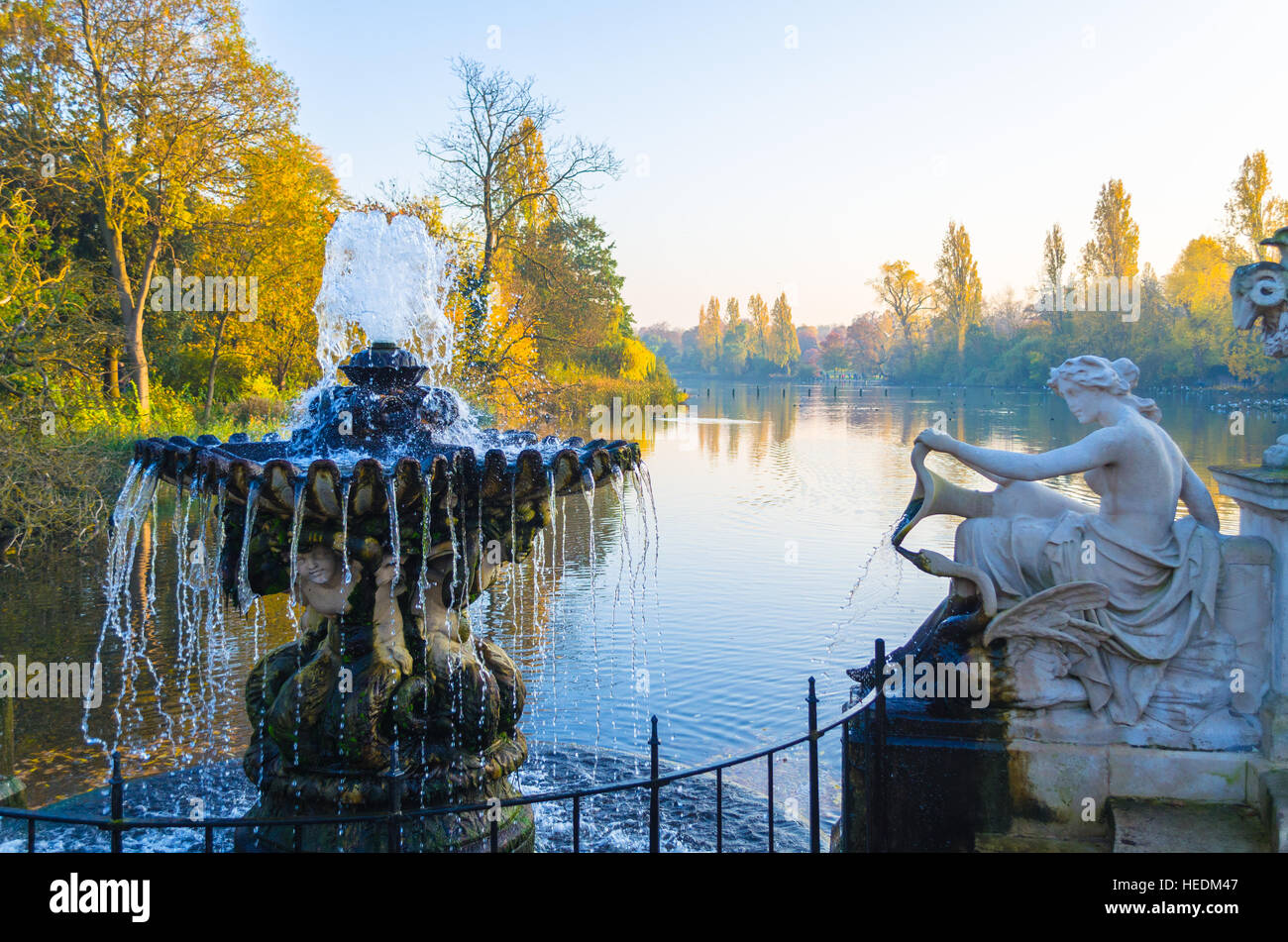 A sculpture and fountain by the Serpentine Lake at Hyde Park in autumn, London Stock Photo