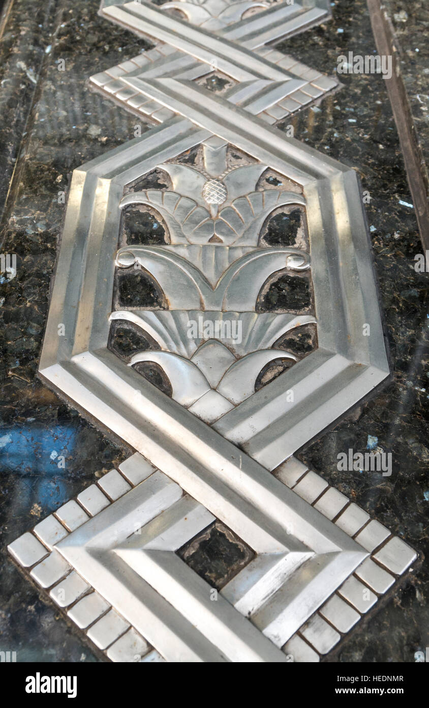 Art deco metal work relief inlaid into marble or granite outside the