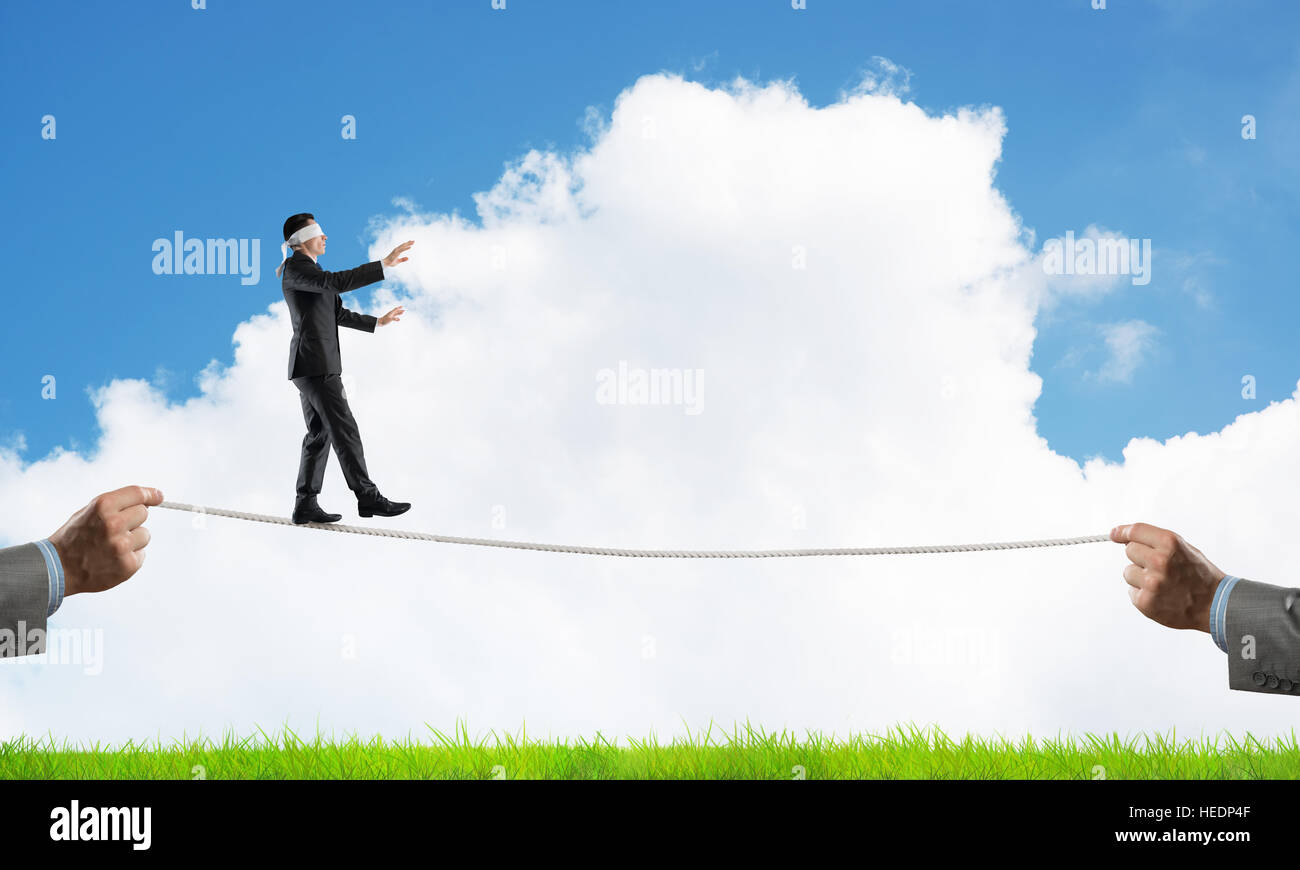 Business concept of risk support and assistance with man balancing on ...
