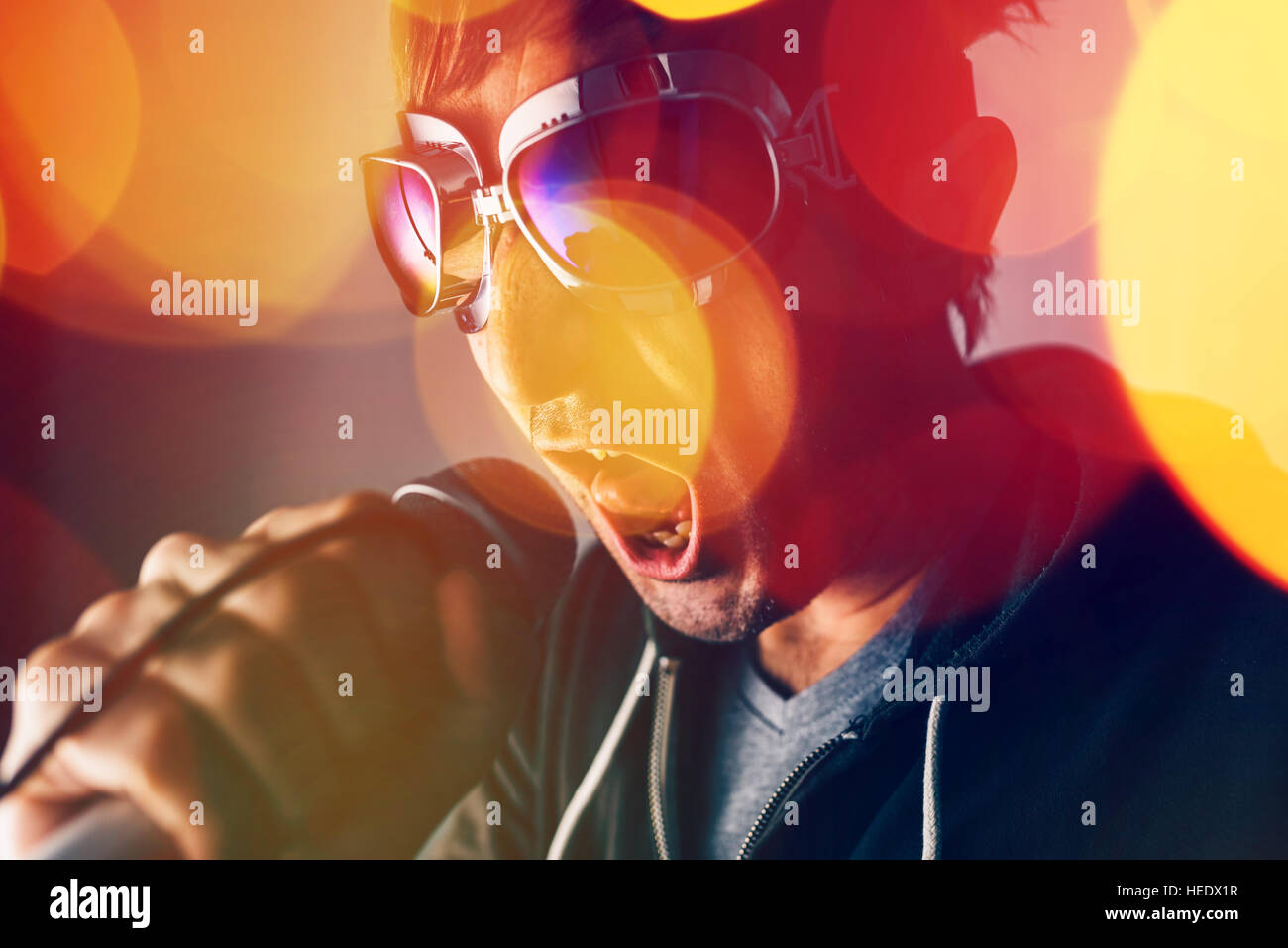 Alternative rock music singer singing song into microphone, bokeh light