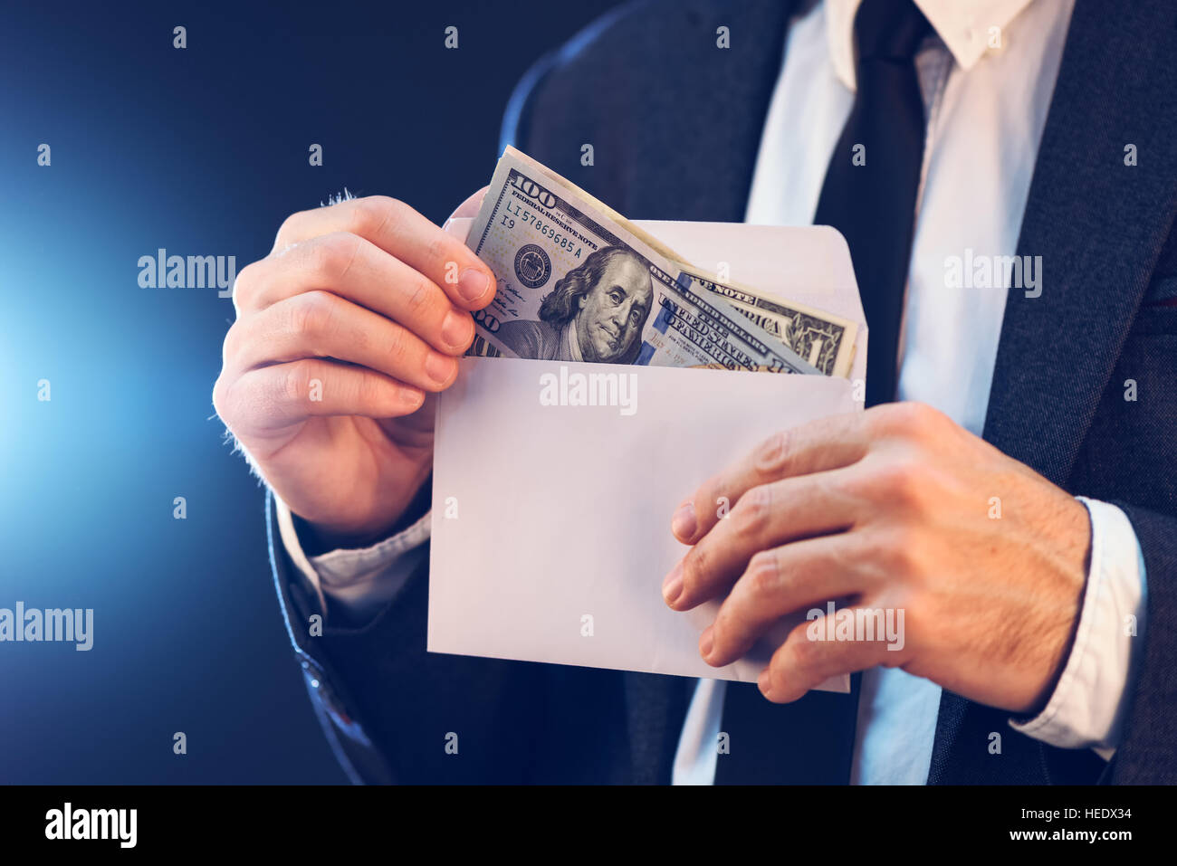 Bribery and corruption concept in business and politics with caucasian businessman and cash money in white envelope Stock Photo