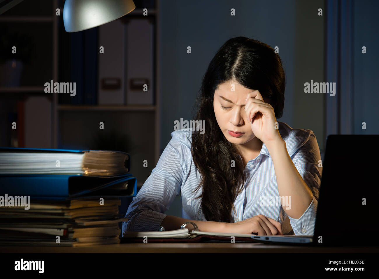 asian business woman sitting at desk headache overtime working late ...