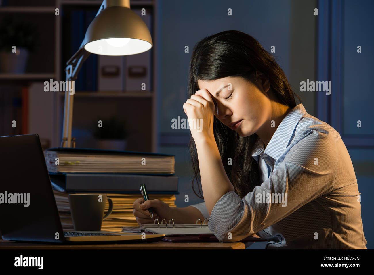 asian business woman sitting at desk headache overtime working late ...