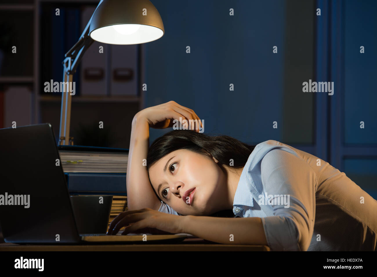 Asian Business Woman Sitting At Desk Sleepy Working Overtime Late