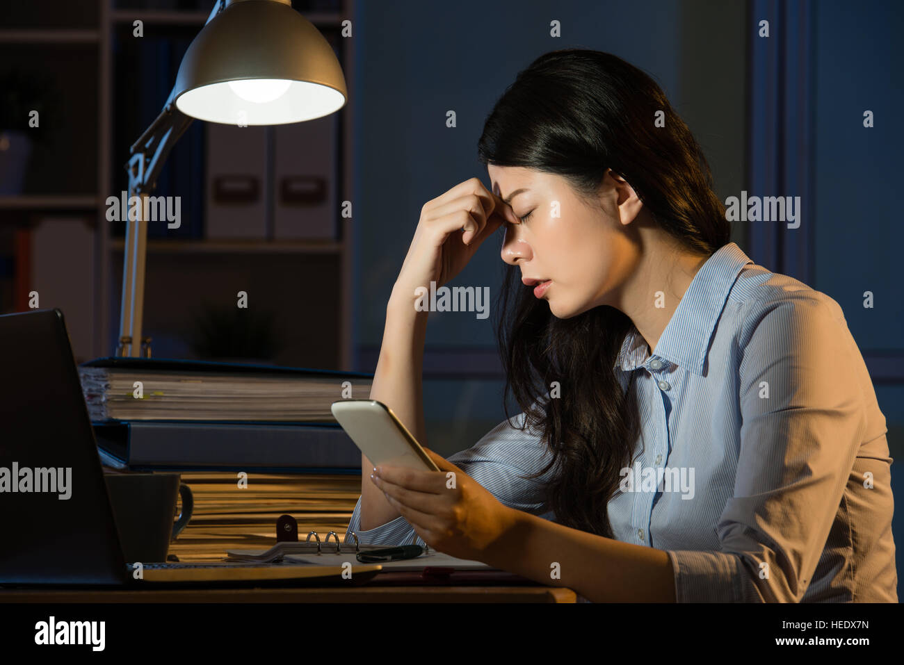 Asian woman phone headache hi-res stock photography and images - Alamy