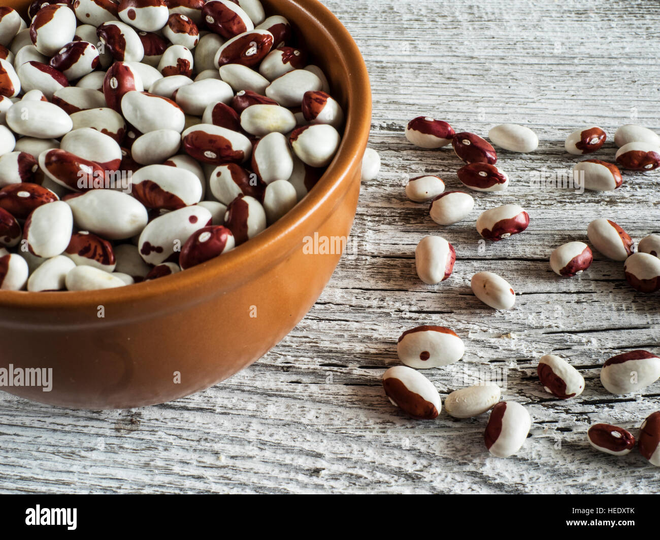 cup with Red and white pea beans on old weathered table Stock Photo Alamy