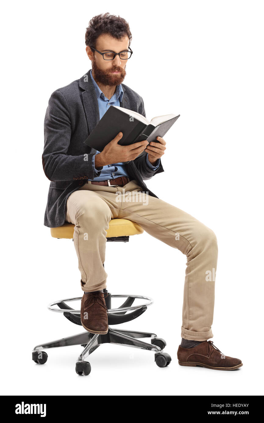 Man sitting on a chair and reading a book isolated on white background ...
