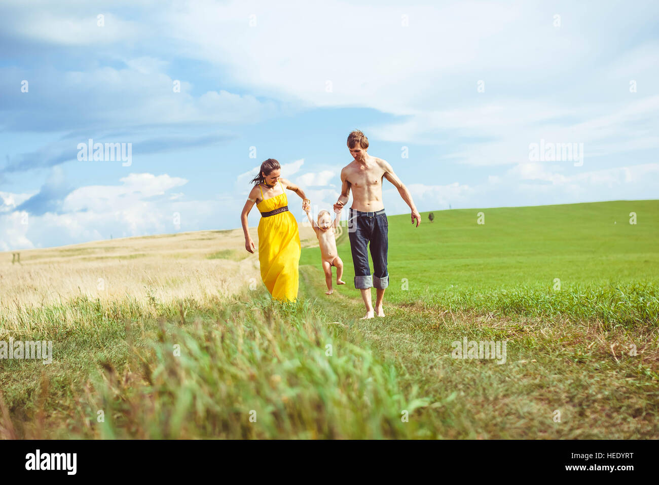 parents walking with baby in nature Stock Photo