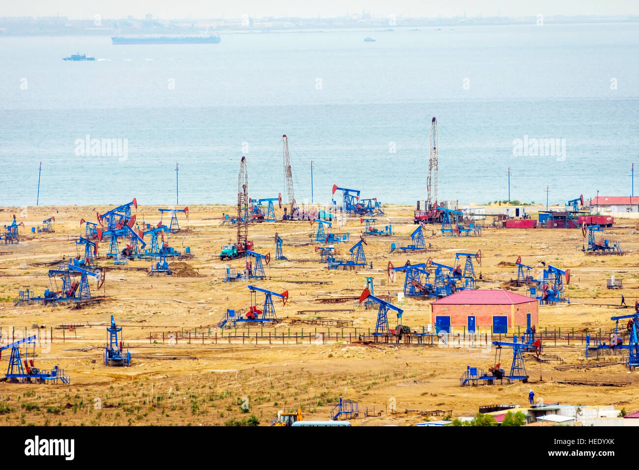 Oil pumps and rigs at the field by Caspian sea near Baku, Azerbaijan Stock Photo