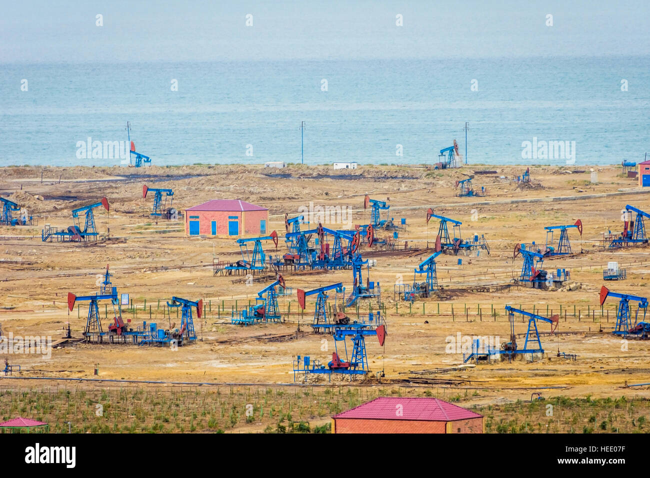 Oil pumps and rigs at the field by Caspian sea near Baku, Azerbaijan Stock Photo