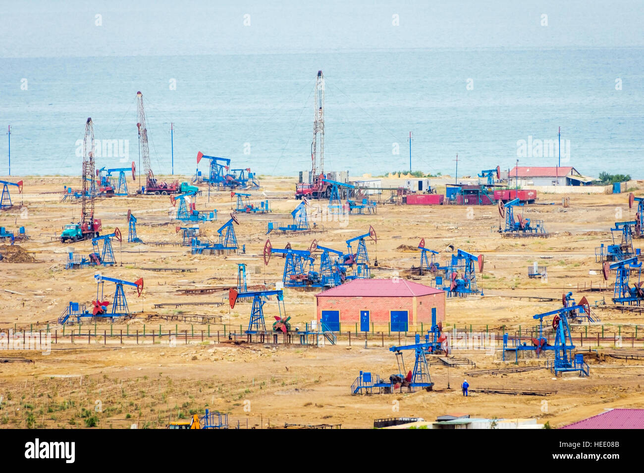 Oil pumps and rigs at the field by Caspian sea near Baku, Azerbaijan Stock Photo