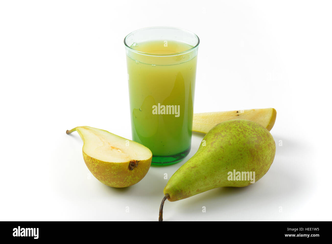 glass of pear juice and fresh pears next to it Stock Photo