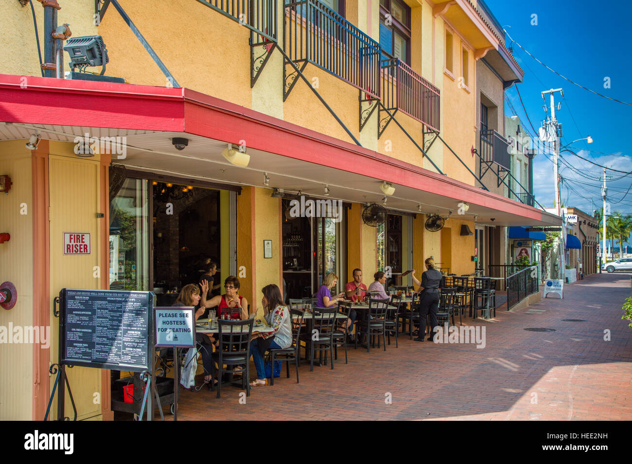 Outdoor dining on sidewalk at restaurant on First Street in Fort Myers Florida Stock Photo