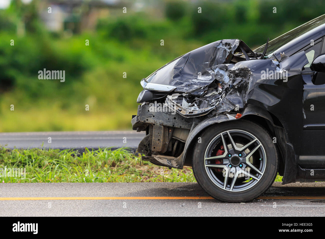 Front of black car get damaged by accident on the road Stock Photo