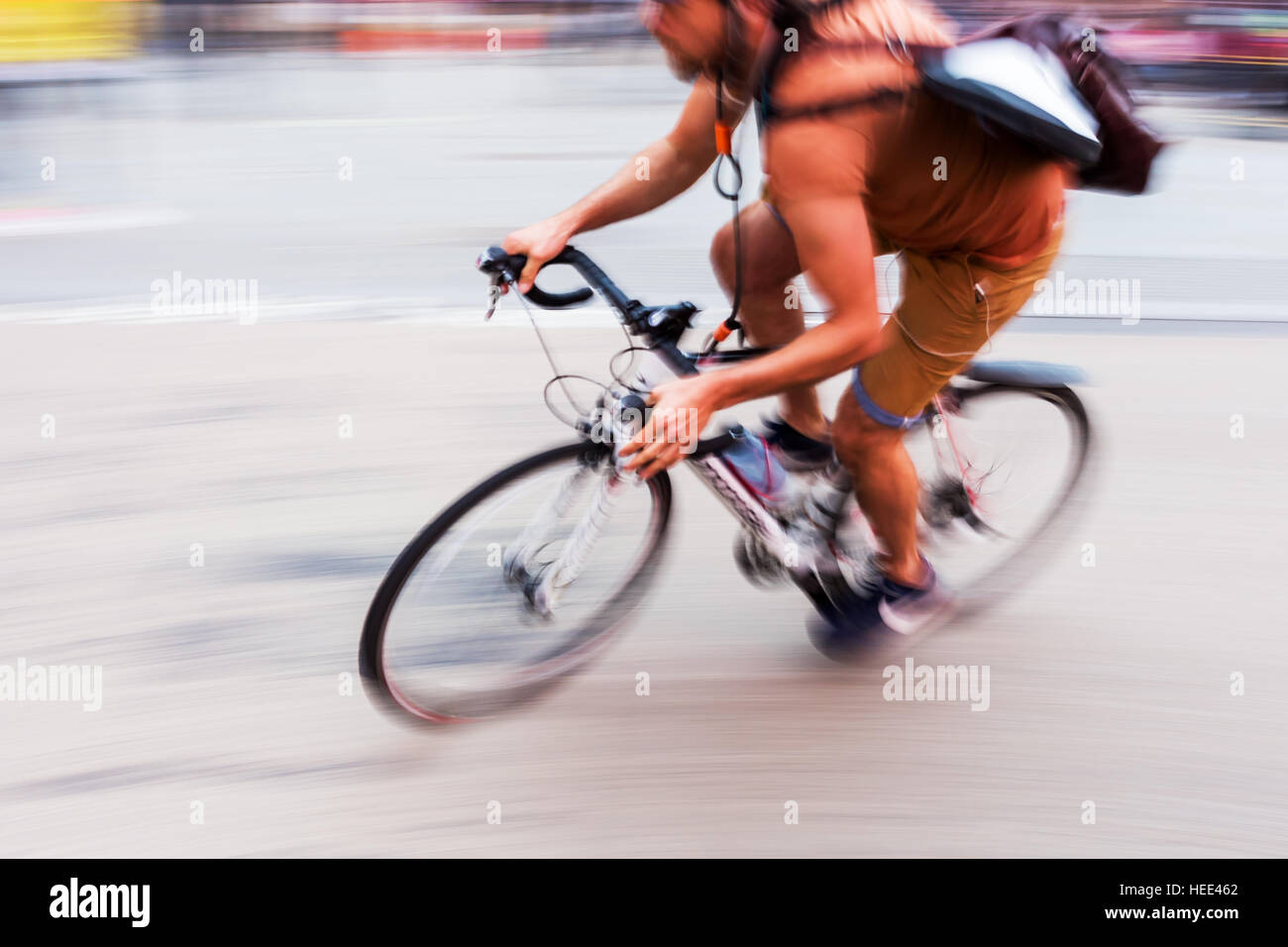 bicycle messenger on the road, shown in motion blur Stock Photo Alamy