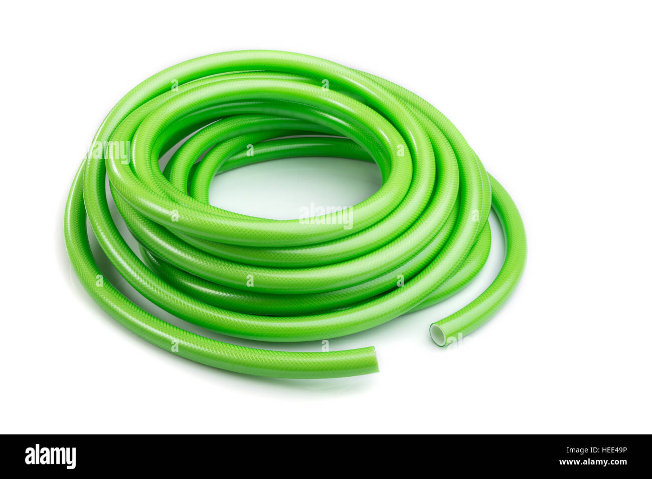 Close up green garden water hose isolated on white background Stock
