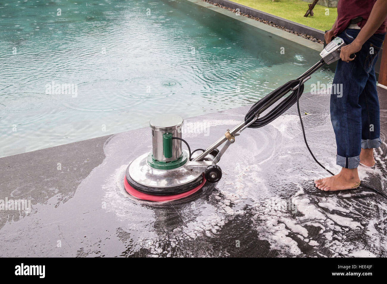 Exterior black stone floor cleaning with polishing machine and chemical