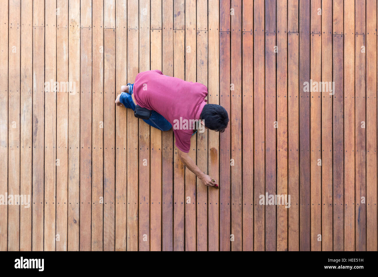 A worker painting exterior wooden pool deck, Top view Stock Photo Alamy
