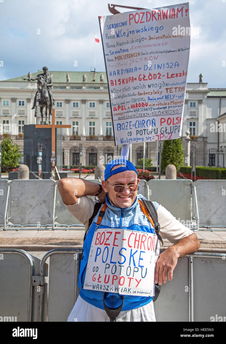 WARSAW, POLAND - AUGUST 29, 2010: demonstrant with a poster with the inscription: 'God, keep Poland out of the stupidity' at the central square of War Stock Photo