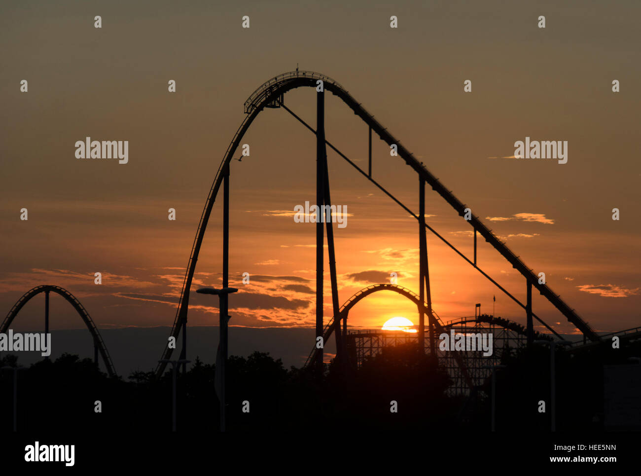 Silhouette of roller coaster at sunset Stock Photo