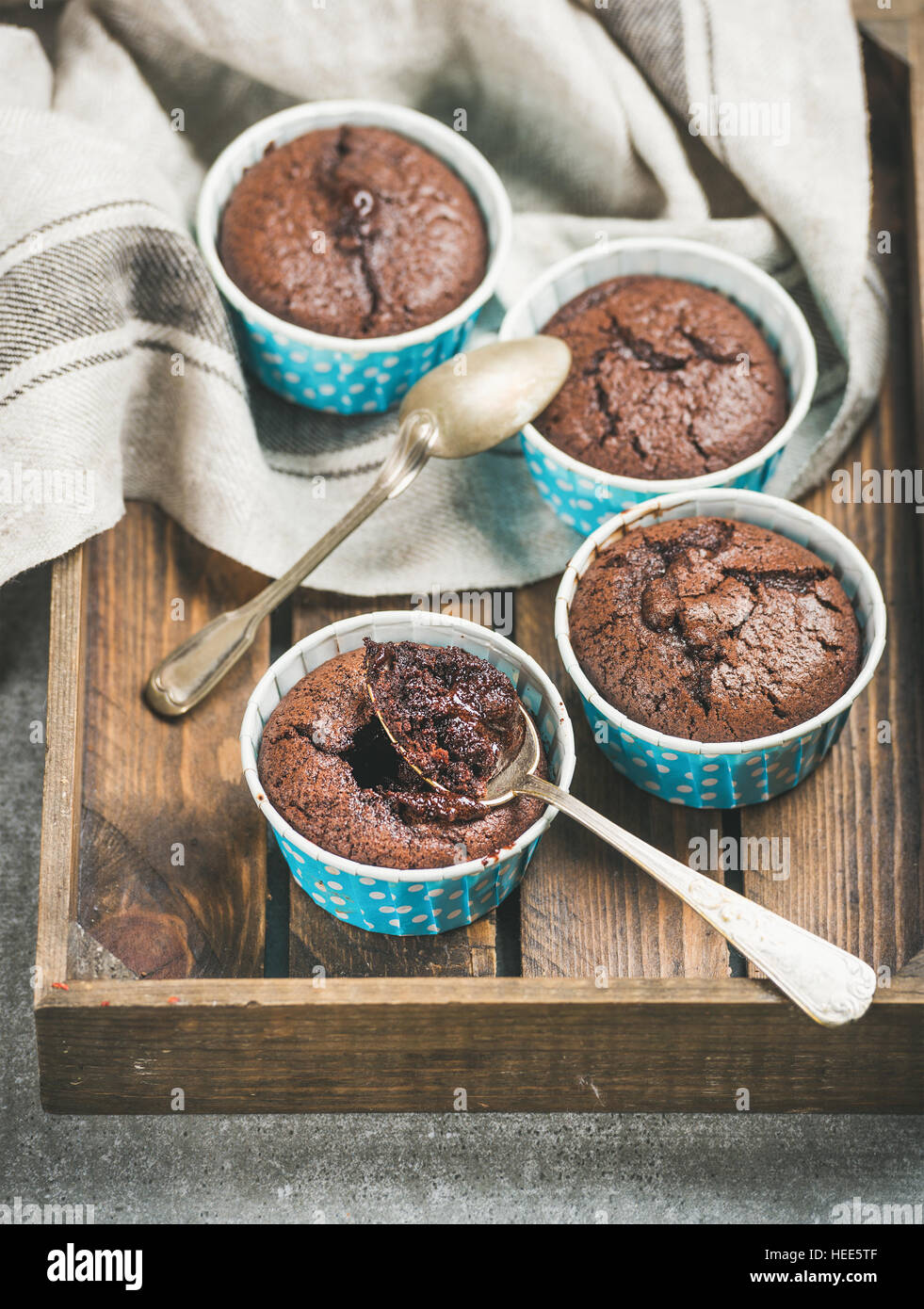 Chocolate souffle in blue individual baking cups in wooden tray Stock