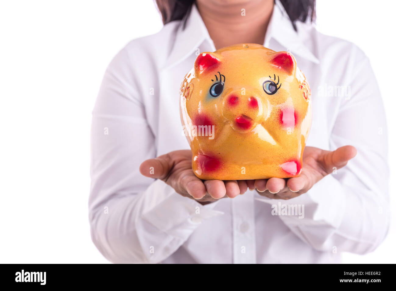 Woman holding yellow piggy bank isolated on white background Stock ...