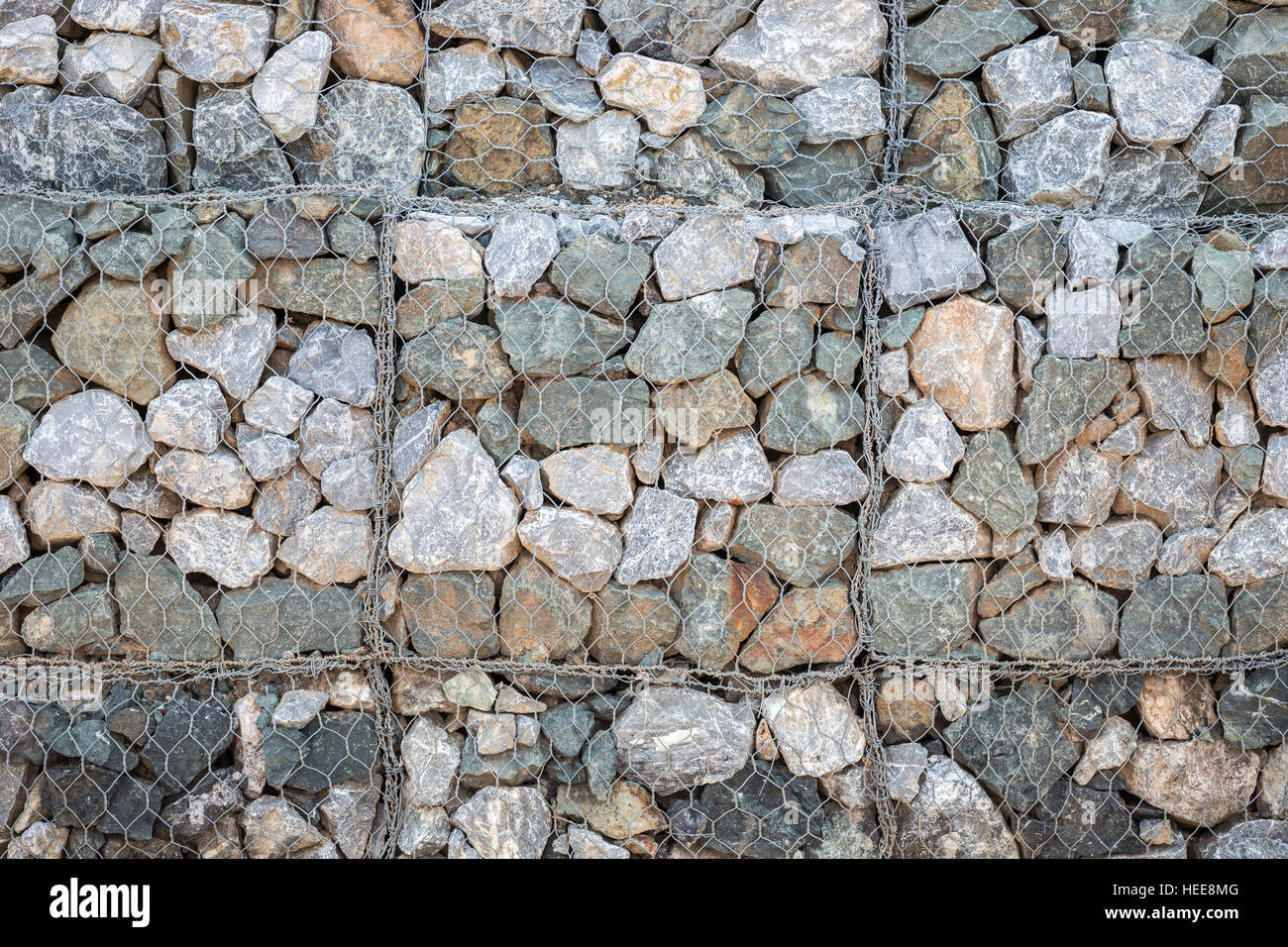 Pattern of grey stone wall with metal grid texture and background Stock Photo