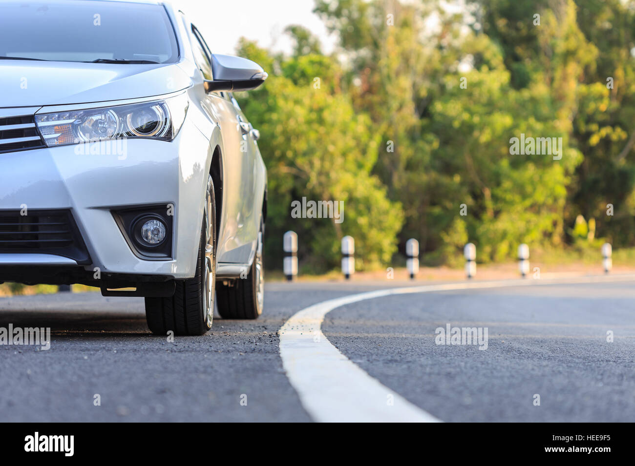 Close up front of new silver car parking on the asphalt road Stock Photo