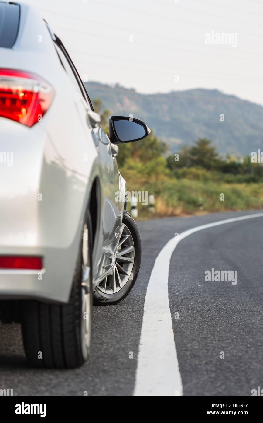 Close up back side of new silver car parking on the asphalt road Stock Photo