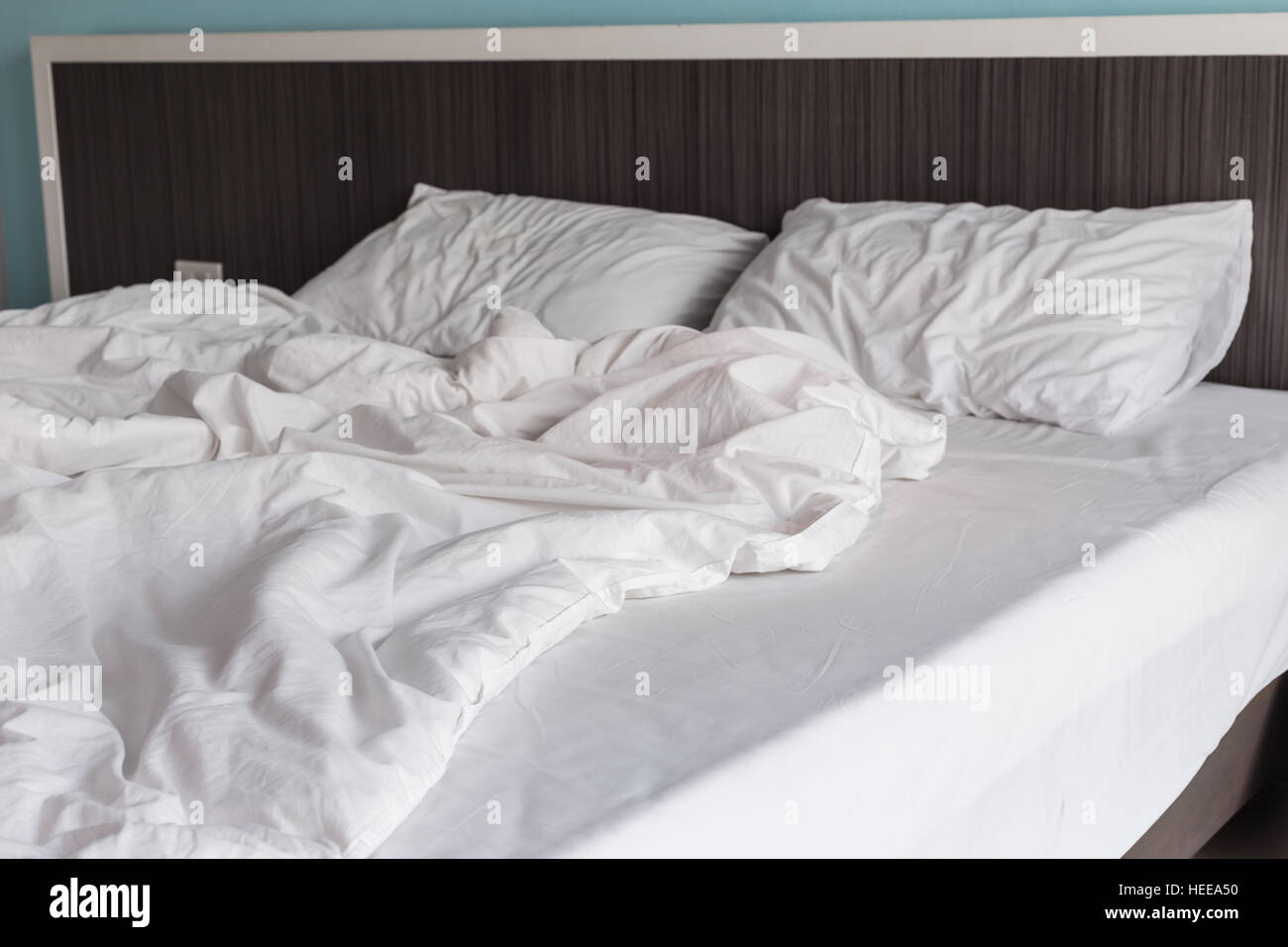 Close up white bedding sheets and pillow, Messy bed concept Stock Photo