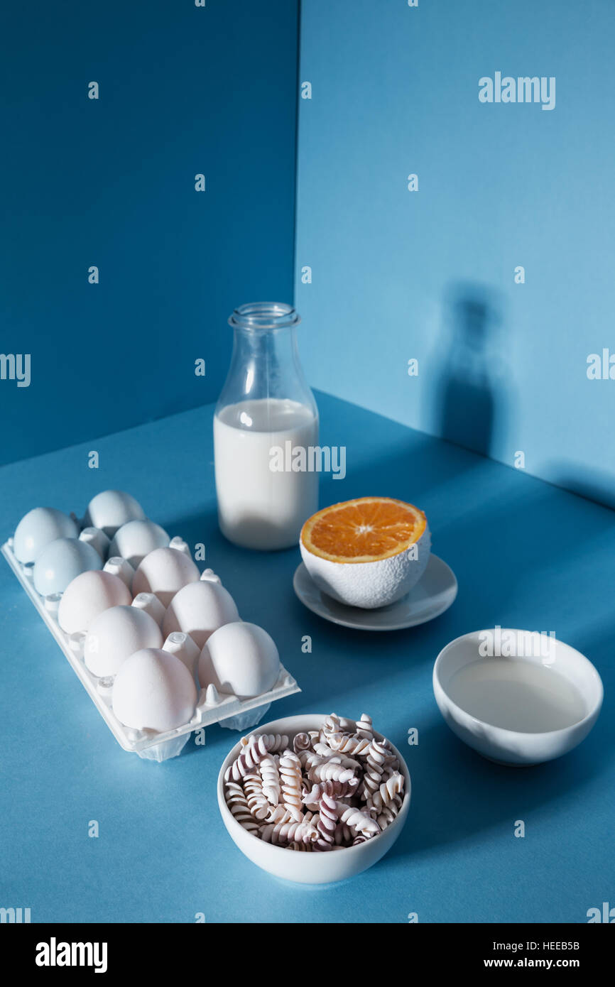 Bottle Of Milk Eggs Pasta And Orange Half Over Blue Background Stock Photo Alamy Bottle Of Milk Eggs Pasta And Orange Half Over Blue Background Stock Photo Alamy