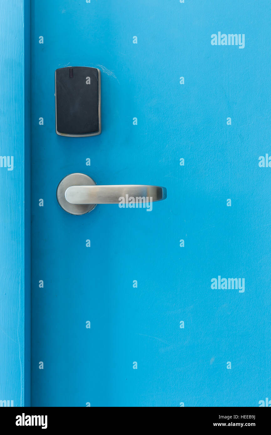 Blue entrance door with electronic keycard lock system Stock Photo