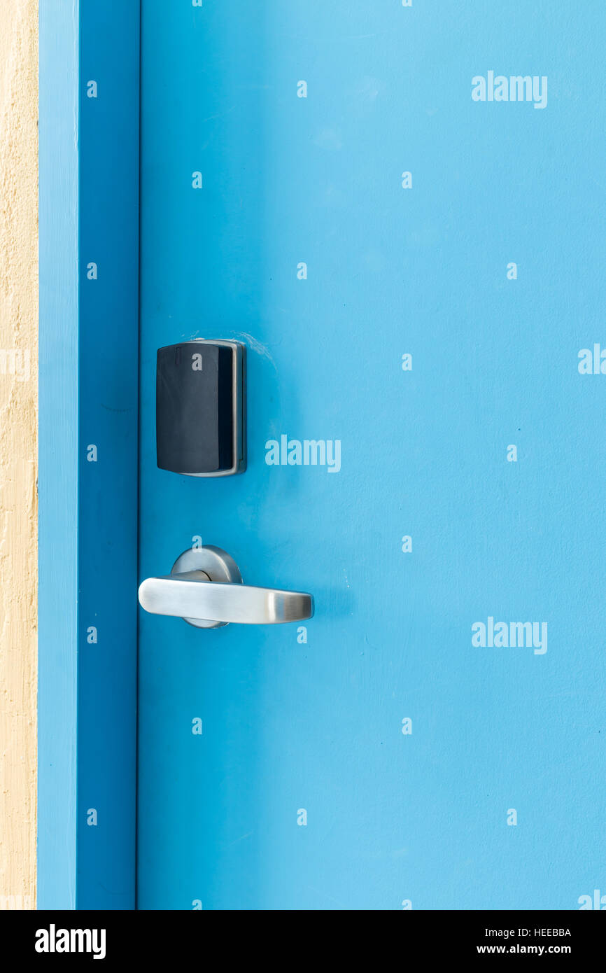 Blue entrance door with electronic keycard lock system Stock Photo