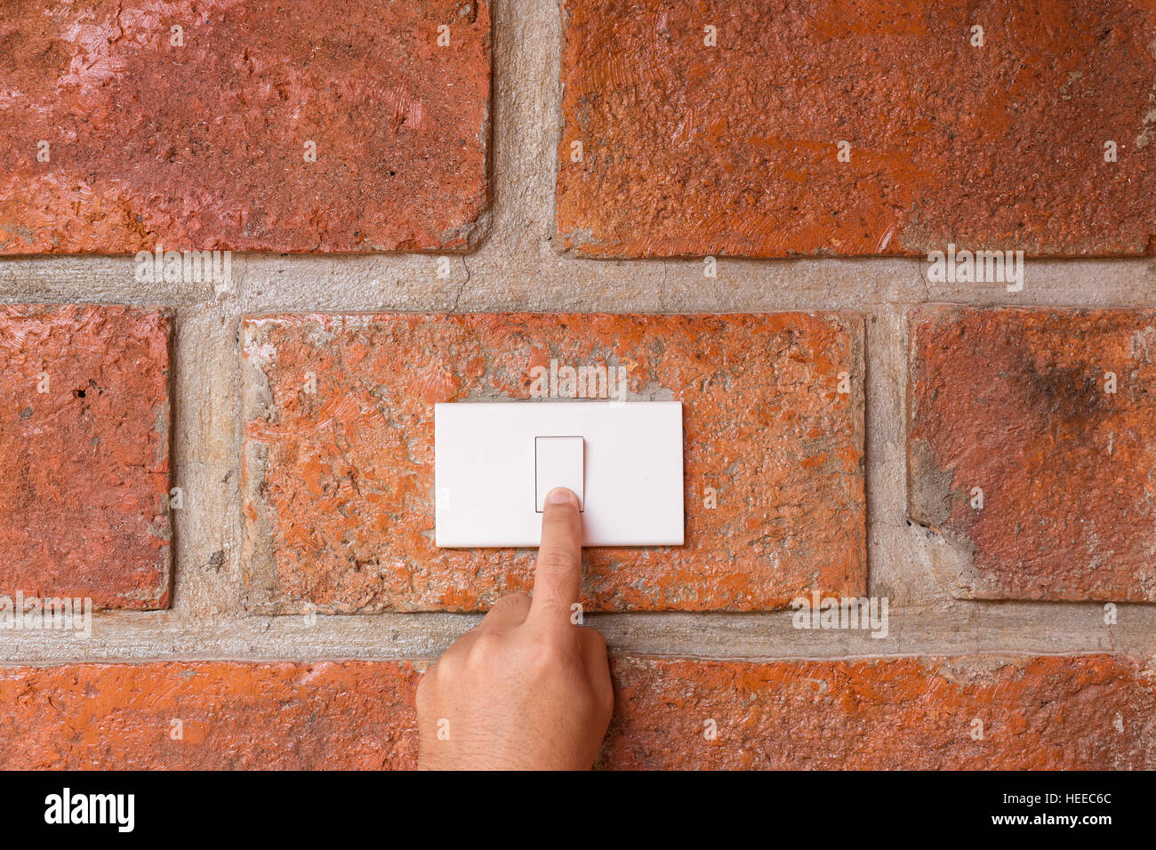 Close up hand turn off light switch on the red wall Stock Photo Alamy