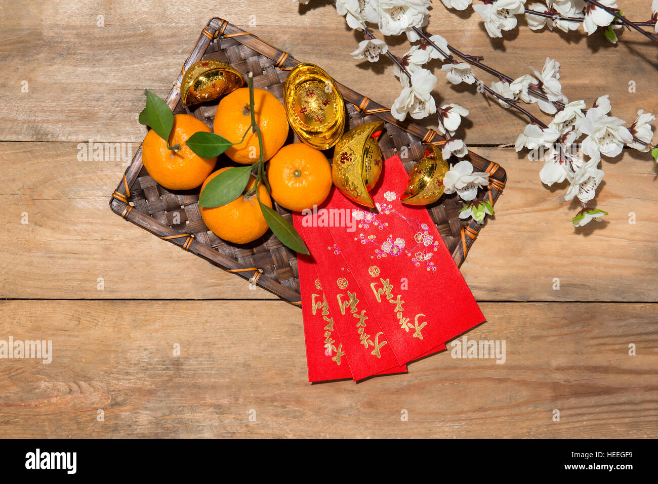 Mandarin oranges and Lunar New Year with text 'Happy New Year' on red pocket. Tet Holiday concept. Text mean Lucky & Happiness. Stock Photo