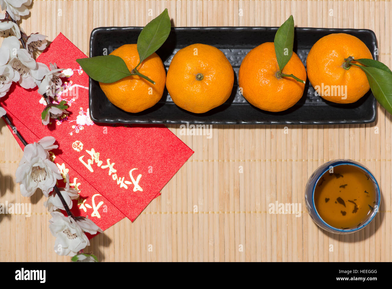 Mandarin oranges and Lunar New Year with text "Happy New Year" on red