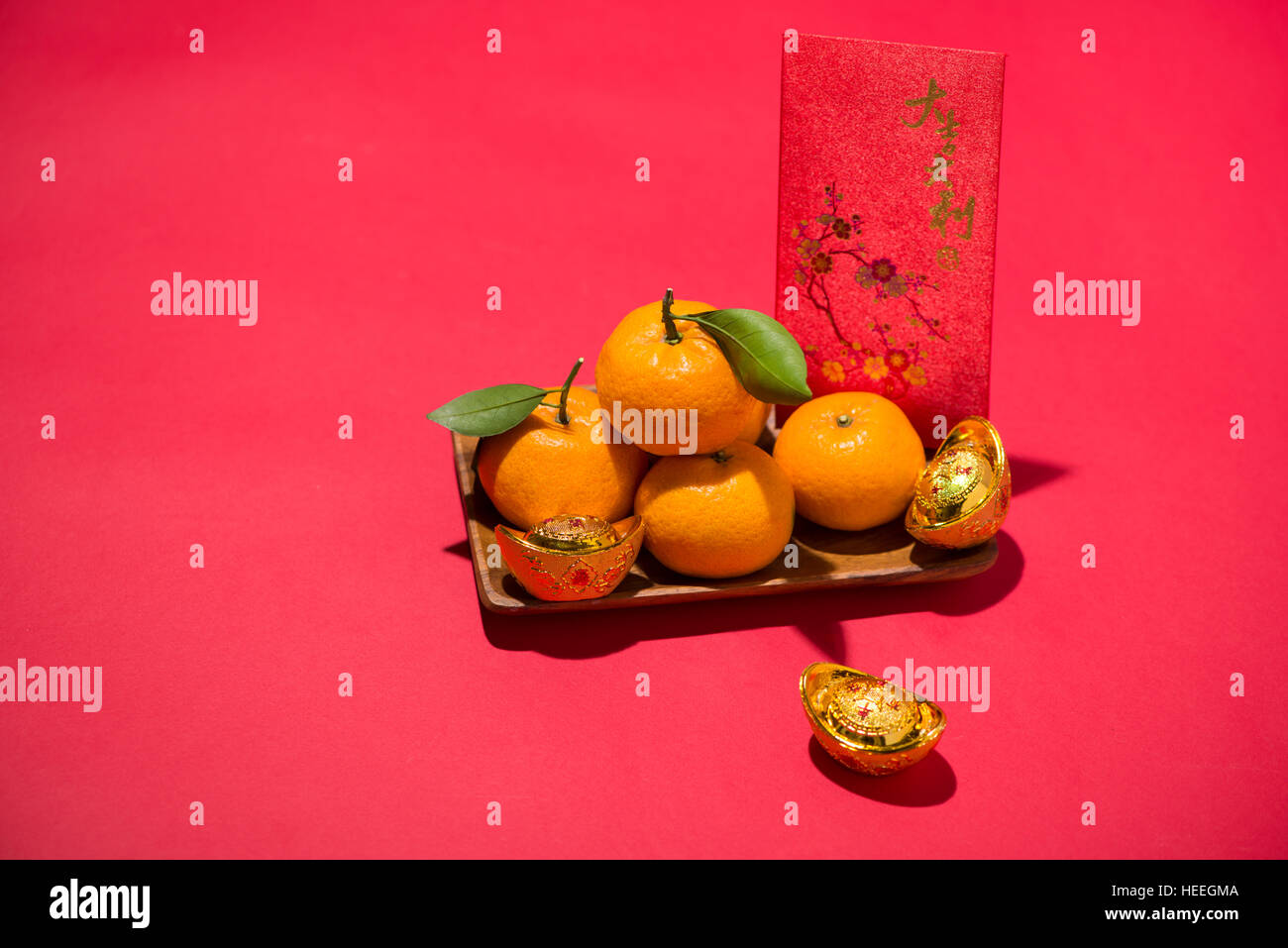 Chinese Lunar new year. Mandarin orange with angbao on red background