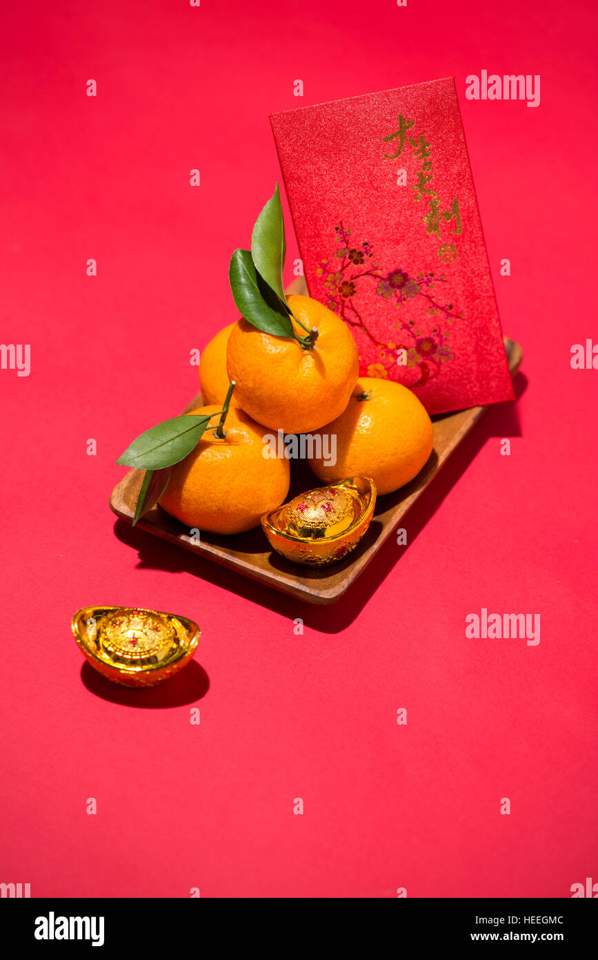 Chinese Lunar new year. Mandarin orange with angbao on red background Stock Photo