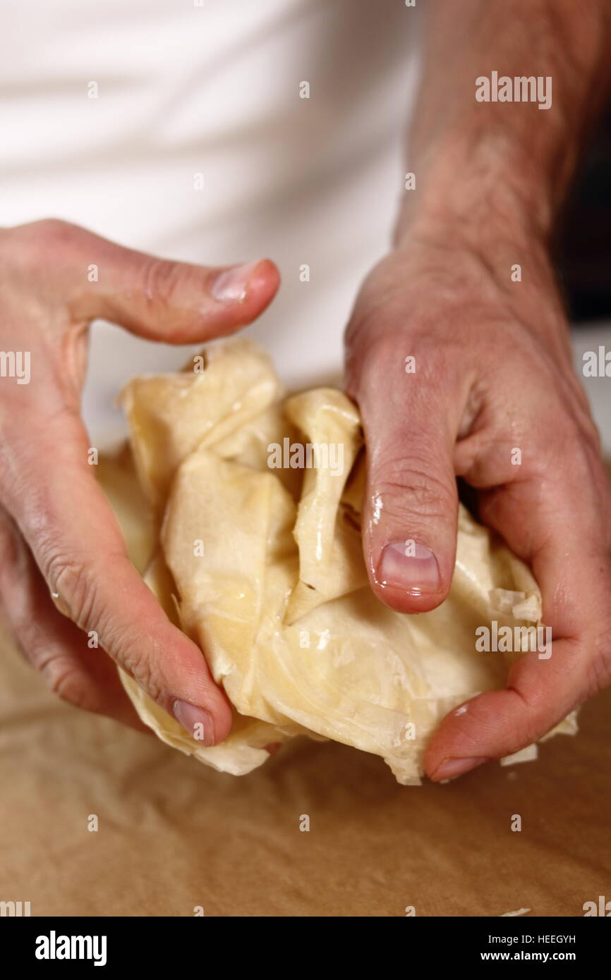 Scrunch up. Making Filo Pastry Topped Apple Pie Series. Stock Photo